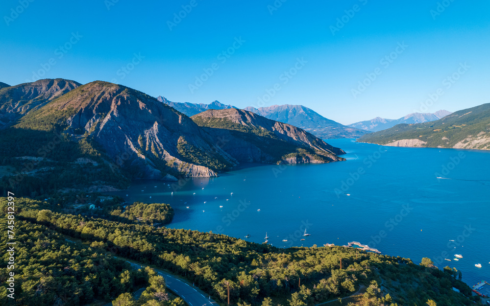 Aerial photography by drone of the Serre-Ponçon lake and its mountains, located in the Hautes-Alpes in France