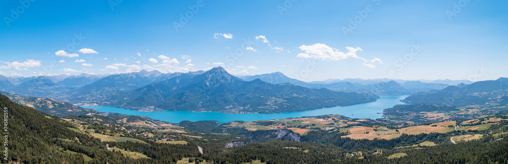 Aerial photography by drone of the Serre-Ponçon lake and its mountains, located in the Hautes-Alpes in France Aerial photography by drone of the Serre-Ponçon lake and its mountains, located in the Hautes-Alpes in France