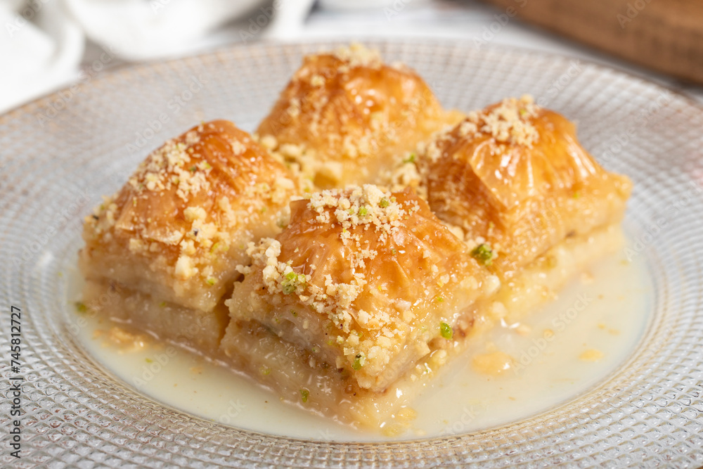 Baklava with milk. Milk baklava with hazelnuts on a white background. Local name sütlü nuriye baklava. Close up Baklava with milk. Milk baklava with hazelnuts on a white background. Local name sütlü nuriye baklava. Close up