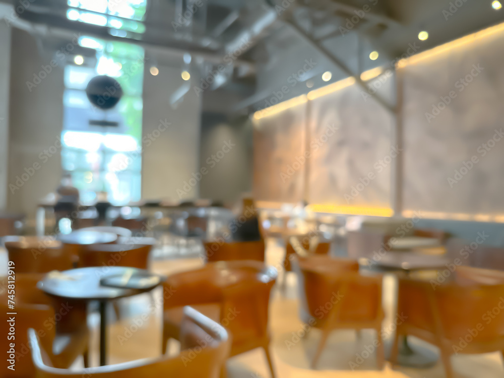 A blurred image of a modern coffee shop, elegantly decorated and warm, with customers happily working A blurred image of a modern coffee shop, elegantly decorated and warm, with customers happily working