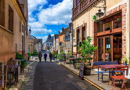 Fototapeta Naklejka Na Ścianę i Meble -  Old street with old houses and tables of cafe in a small town Chartres, France
