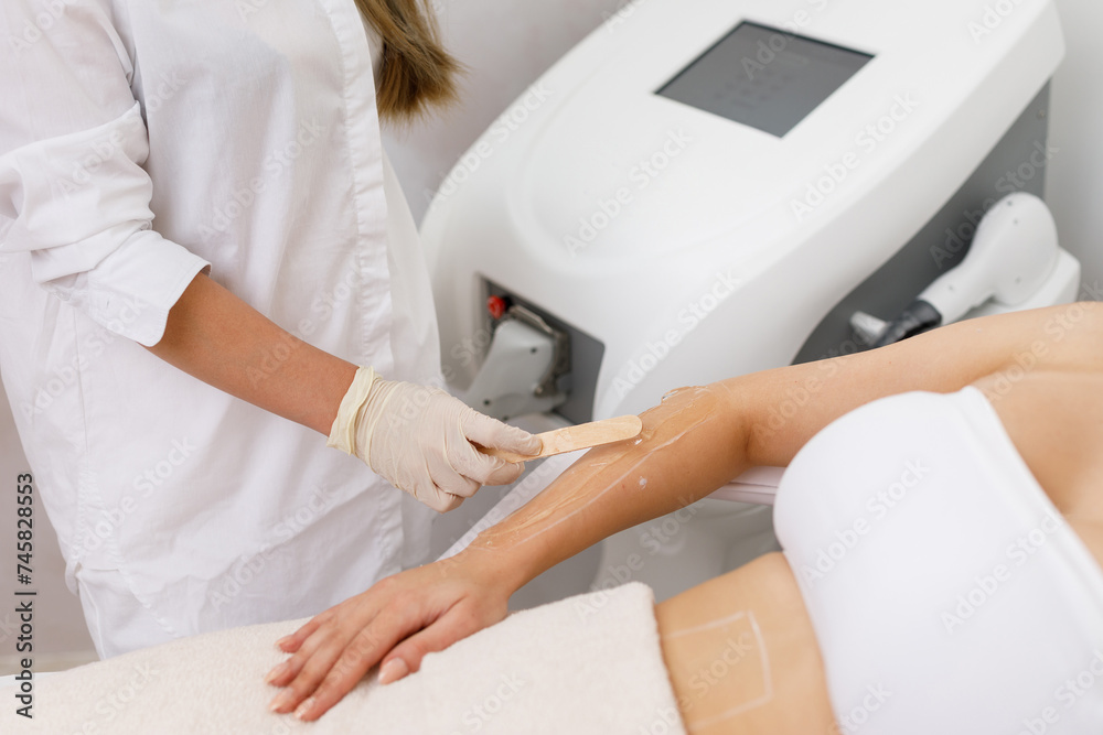 Laser epilation and cosmetology in beauty salon. Hair removal procedure. Laser epilation, cosmetology, spa, and hair removal concept, say goodbye hair on legs, armpit, bikini zone.
