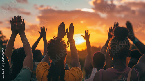 A diverse group of people supporting each other, with hands raised in unity, against a sunrise background, symbolizing mental health solidarity.