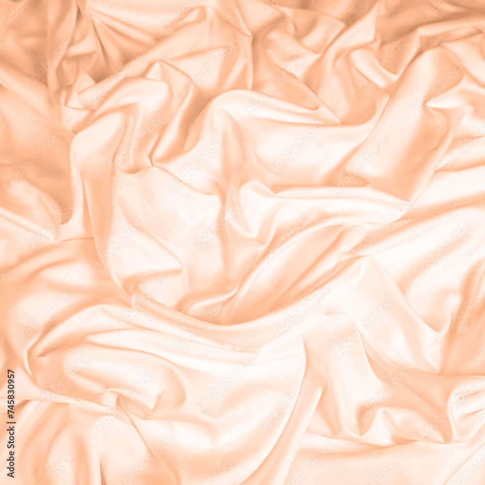 Obraz premium Waves and patterns of crumpled natural satin fabric. Color of the year 2024 Peach Fuzz