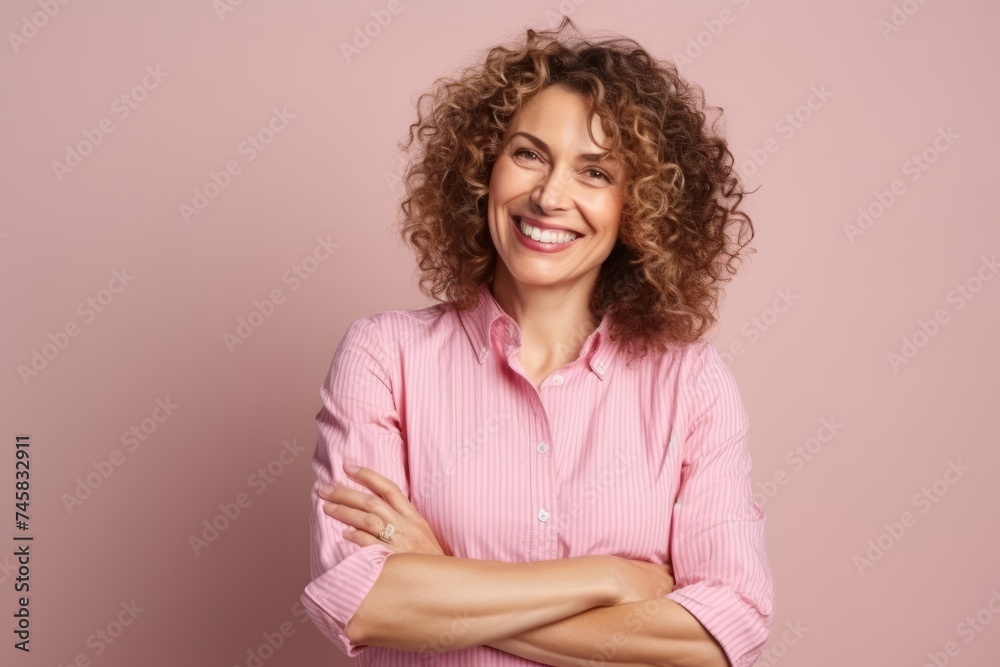Portrait of a smiling young woman with curly hair over pink background Portrait of a smiling young woman with curly hair over pink background