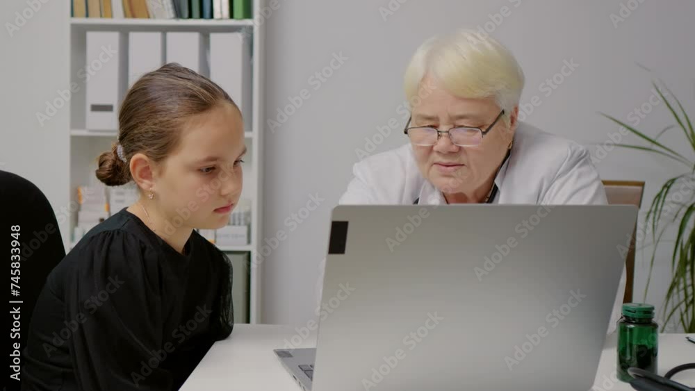 Doctor showing results to girl on laptop. Concept of medical, healthcare, healthy family, pediatric checkup and hospital office.