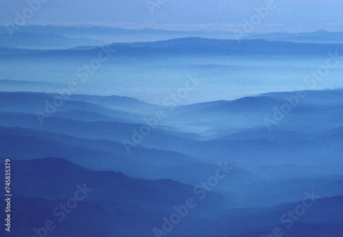 aerial of the Alps in foggy mood