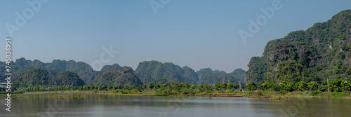 Panoramic views of Ninh Binh Countryside with Green mountains, blue skies and rice fields in Vietnam