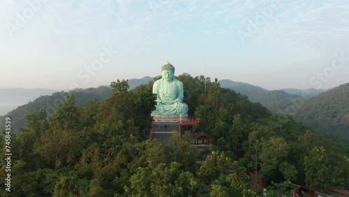 Aerial view of The Great Buddha at Doi Phra Chan is a towering bronze Buddha statue that can be reached by climbing 628 steps up at wat Prathat Doi Prachan, Pa Tan, Mae Tha District, Lampang, Thailand