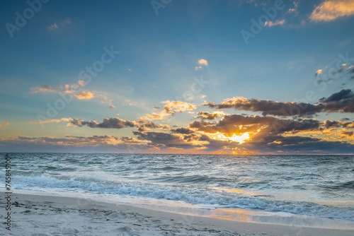 Beautiful sunset cloudscape over light rolling waves © nsc_photography
