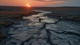 Sunset over Cracked Earth in a Drought-Stricken Landscape