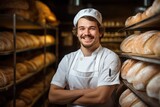 Portrait of a male baker in a bakery with bread and oven in the background.bread production