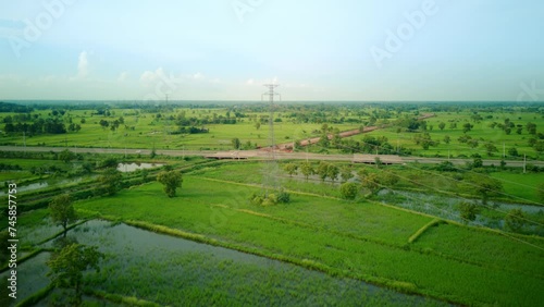 4K Time lapse of High voltage pole, Transmission tower, Electricity pylon, Electric power transmission located on rice field in the countryside at remote area of community