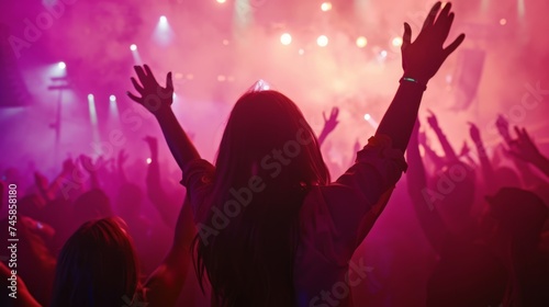 Event crowd. Hands raised. Celebration, event, concert, live show. Stadium. Arena. Happiness and excitement.