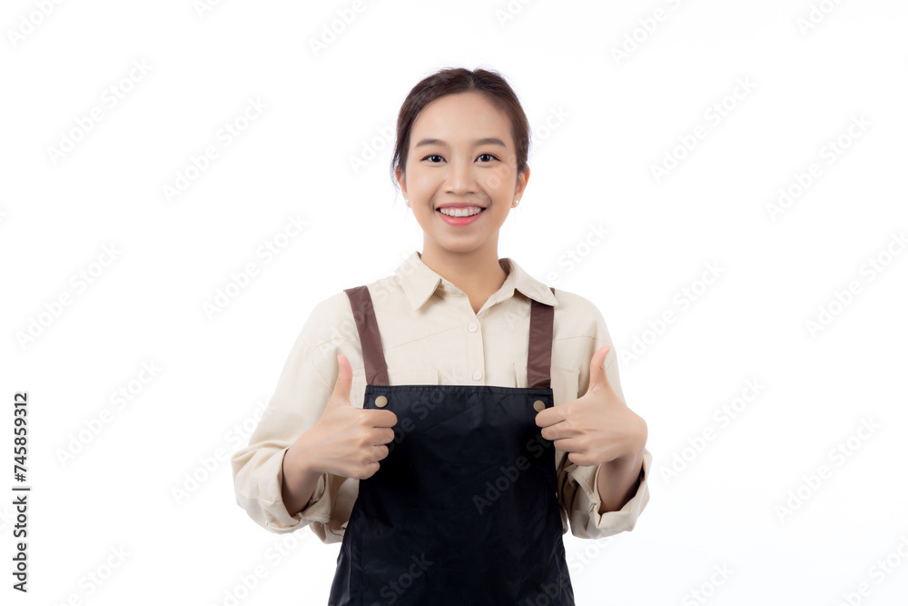 Portrait smiling young asian woman wearing apron showing thumbs up with hand isolated white background, young asian woman making thumbs up gesture, waitress or entrepreneur, small business or startup. Portrait smiling young asian woman wearing apron showing thumbs up with hand isolated white background, young asian woman making thumbs up gesture, waitress or entrepreneur, small business or startup.