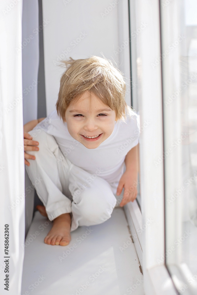 Cute happy toddler boy, child in white cloths, smiling at camera Cute happy toddler boy, child in white cloths, smiling at camera