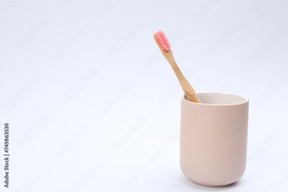 Bamboo toothbrush in holder isolated on white Bamboo toothbrush in holder isolated on white