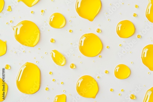 Macro photography close up of yellow liquid drops oil on a white background