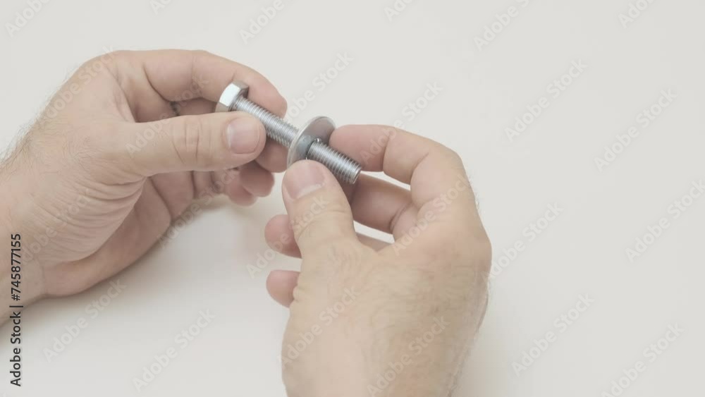 men's hands tighten nut on bolt, close-up, slow motion
men's hands tighten nut on bolt, close-up, slow motion