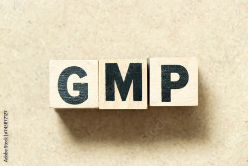 Alphabet letter block in word GMP (Abbreviation of good manufacturing practice) on wood background © bankrx