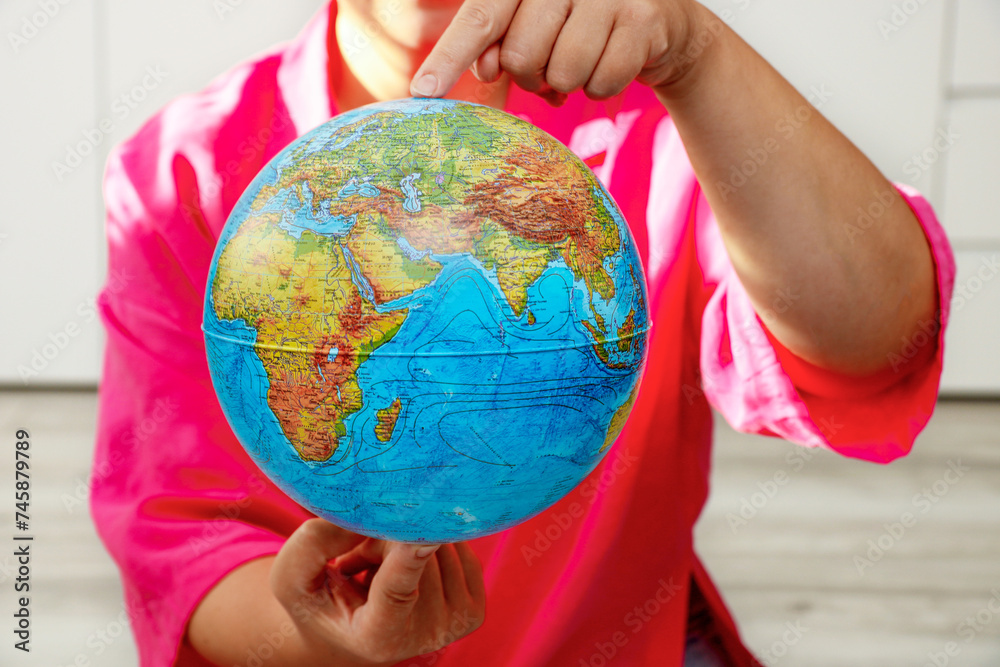 woman holding a physical globe in her hands woman holding a physical globe in her hands