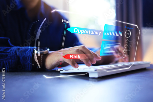 Risk and opportunity assessment concept with businessmen working with computer and data in bar graph format to analyze low risk and high opportunities in business and investment for good profit