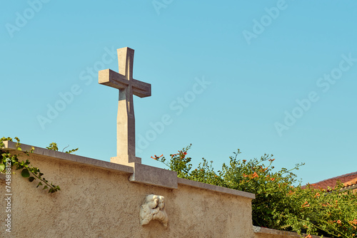 Cross on the wall by the church in the city of Piran, Slovenia