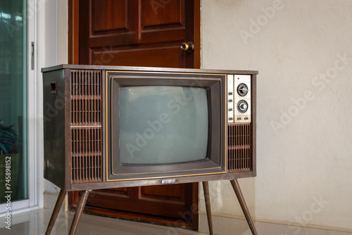 Retro old TV with blank screen standing in the room at home. vintage television with legs