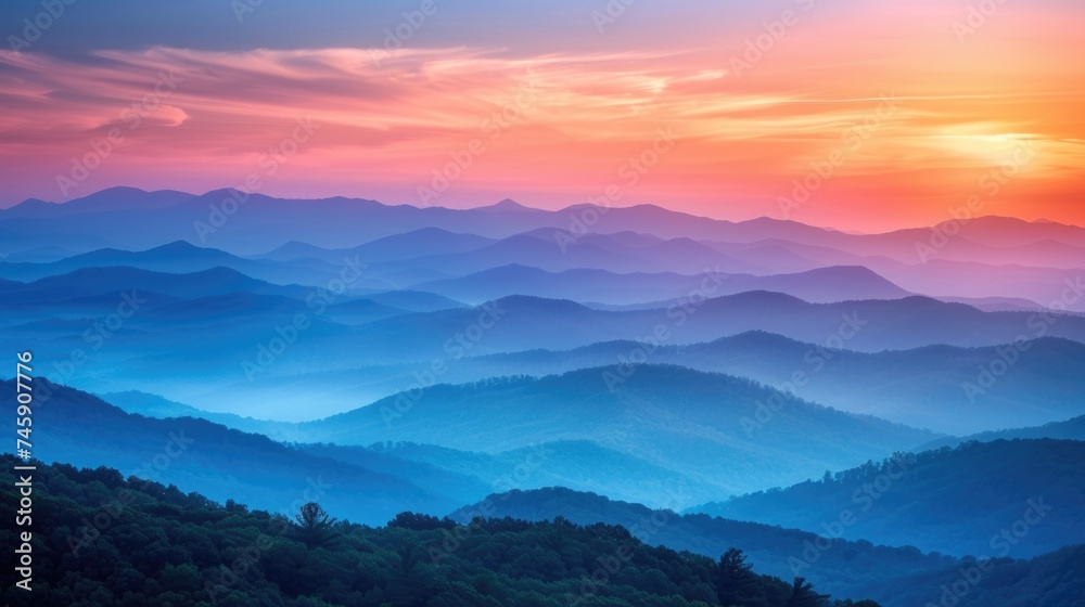 Warm Sunset Glow Over Misty Mountain Layers: A Gradient of Blues to Oranges Across Softened Ridges