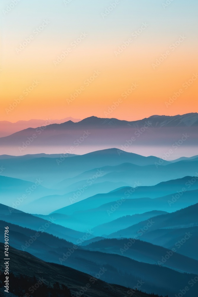 Misty Mountain Panorama at Sunset: Warm Glow Softens the Transition from Blue to Orange Ridges
