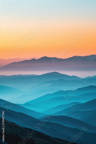 Misty Mountain Panorama at Sunset: Warm Glow Softens the Transition from Blue to Orange Ridges © Landscape Planet