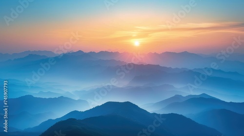 Serene Mountain Sunset: Ethereal Haze and Warm Light Blending Ridges from Blues to Oranges