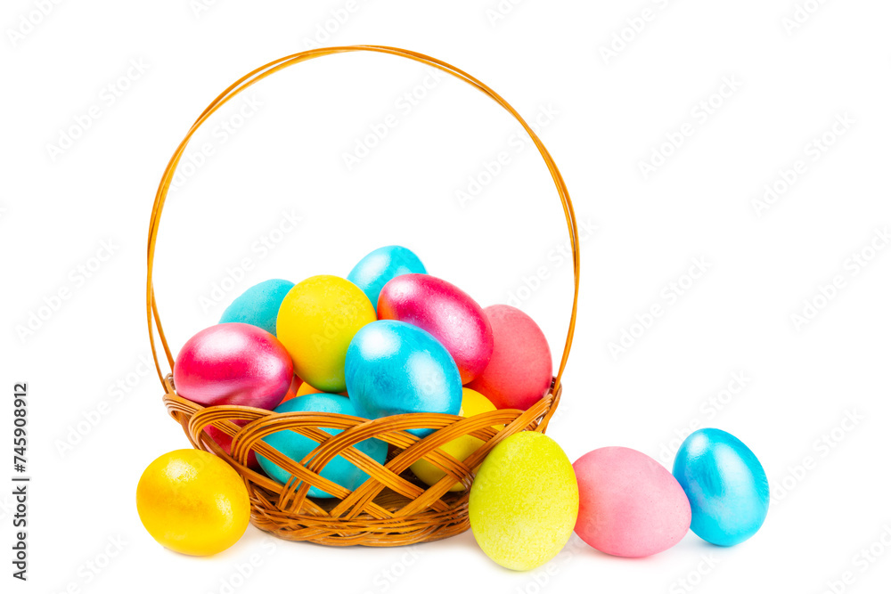 Naklejka premium Easter basket filled with colorful eggs isolated on white background. Easter celebration concept. Colorful easter handmade decorated Easter eggs.