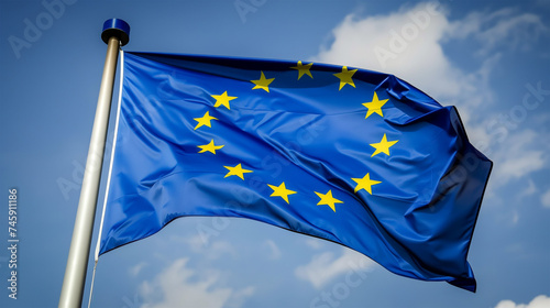 Waving European Union Flag Against Blue Sky Symbolizing Political Integration and Unity.
