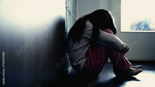 Quadro su tela Sad child suffering from depression sitting alone in corridor feeling loneliness