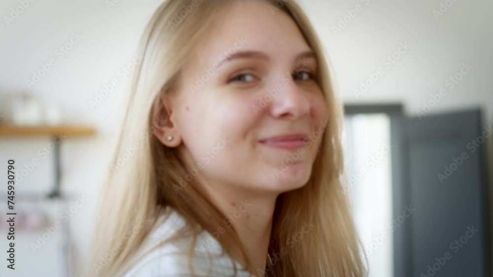 Portrait of a young girl standing in a room and looking at the camera Portrait of a young girl standing in a room and looking at the camera