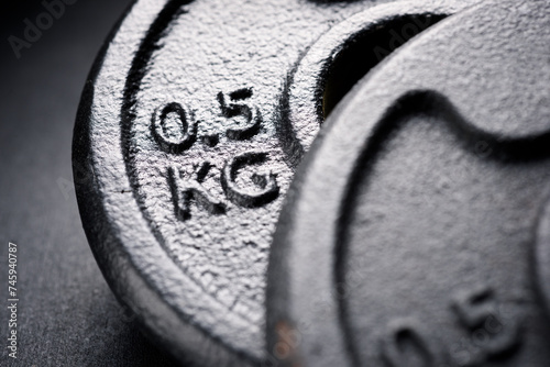 Close-up of two metal gym weights © WINDCOLORS