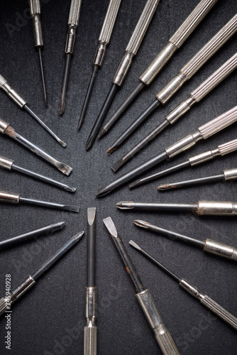 Metal precision screwdriver group on a black table © WINDCOLORS