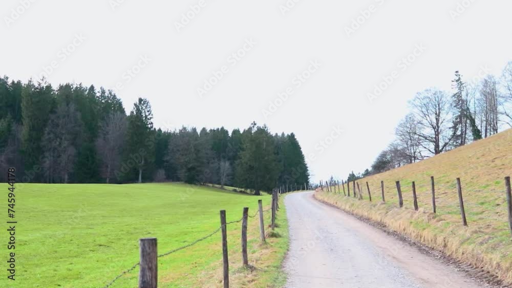 Road in the middle of fields leading to forest and hills, Bavarian mountains, video. Road in the middle of fields leading to forest and hills, Bavarian mountains, video.