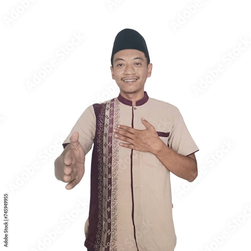 Moslem Asian man smiling friendly while offering a handshake photo