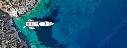 Obraz na płótnie Aerial drone ultra wide top down photo with copy space of luxury yacht anchored in tropical exotic island with crystal clear turquoise sea w salonie