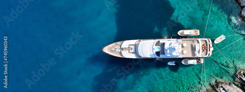 Aerial drone ultra wide top down photo with copy space of luxury yacht anchored in tropical exotic island with crystal clear turquoise sea © aerial-drone