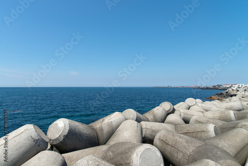 Seascape with tetrapod and blue sky