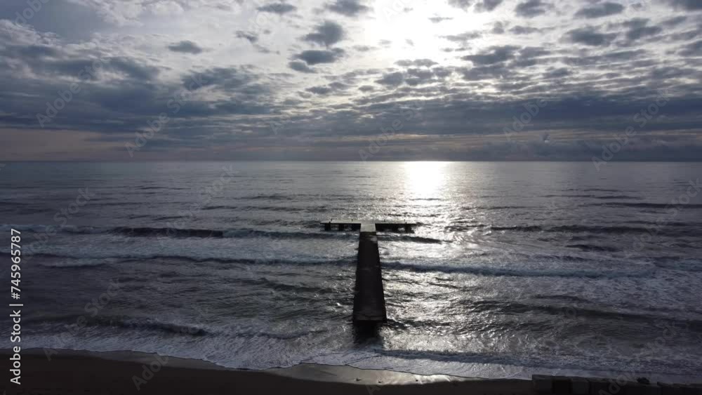 Sunset, aerial view, flyover pier and waves