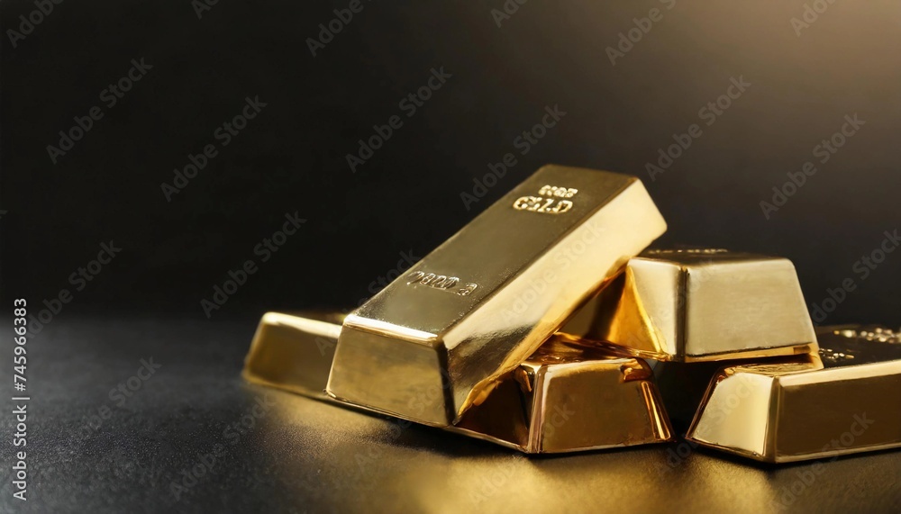 Gold bars and gold nuggets on a dark background, space for text or advertising Gold bars and gold nuggets on a dark background, space for text or advertising