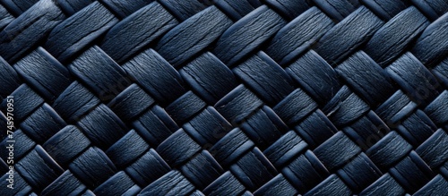 A detailed look at a navy blue woven textile showcasing a wicker pattern, revealing the intricate structure of vintage fabric.