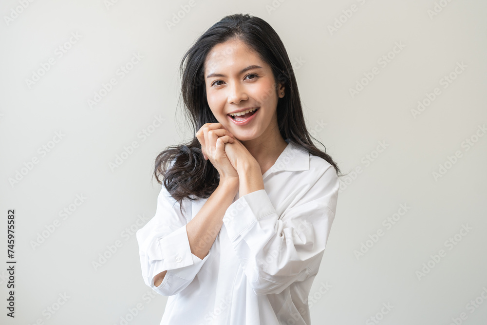 Smile positive, happy asian young woman wearing casual shirt, portrait of beautiful female with black long hair feeling prond, standing gesture cheerful looking at camera, isolated on white background Smile positive, happy asian young woman wearing casual shirt, portrait of beautiful female with black long hair feeling prond, standing gesture cheerful looking at camera, isolated on white background
