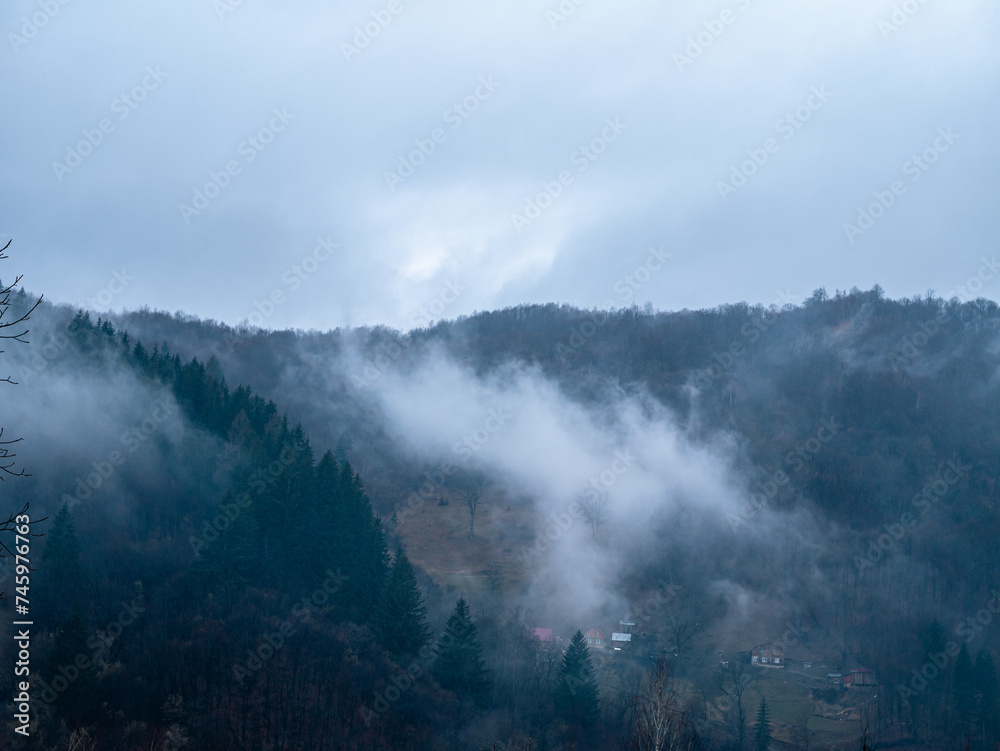 Fototapeta premium Misty Carpathian Mountains fog clouds landscape. Foggy atmospheric morning green fir trees Scenic forest rainy day. Calm tranquil Carpathians summit wood, Ukraine Europe travel. Eco Tourism Recreation