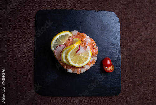 Top view Exquisite Salmon Tartare with Fresh Lemon and Crisp Radish Garnish photo