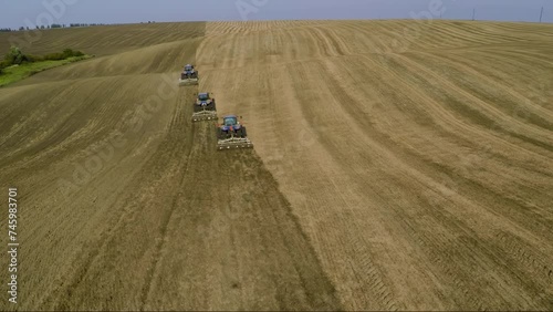 Aerial view. Tractors working in an agricultural field. Agricultural Ukraine. photo